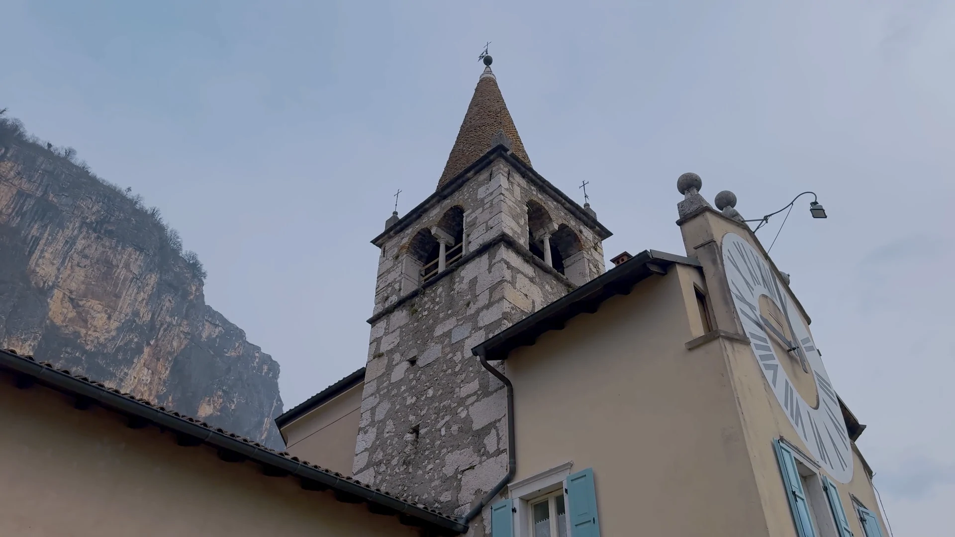 The bell tower and church at Montealbano beneath the mountain ridge